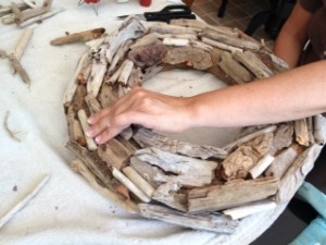 Continue adding driftwood until the entire wreath form is covered.